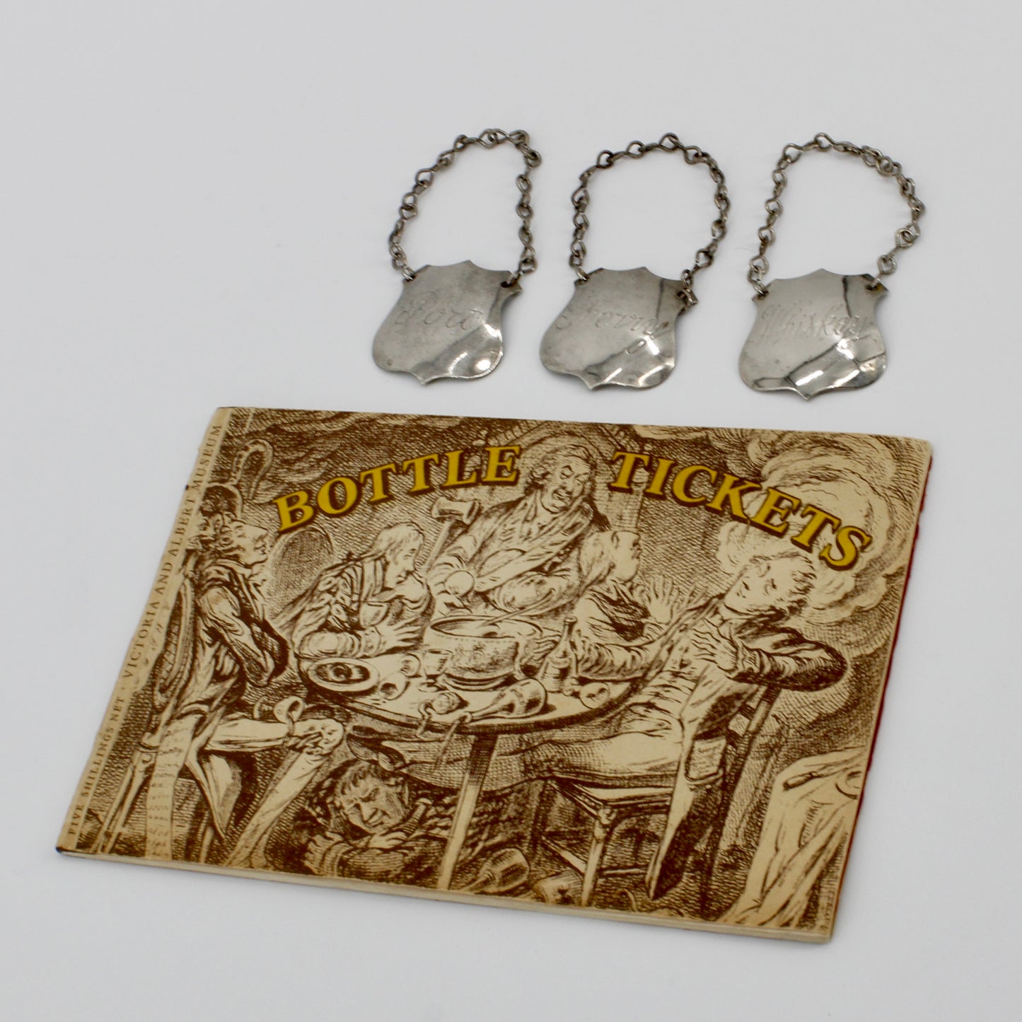 Trio of Sterling Silver Bottle Tags & Antique Book