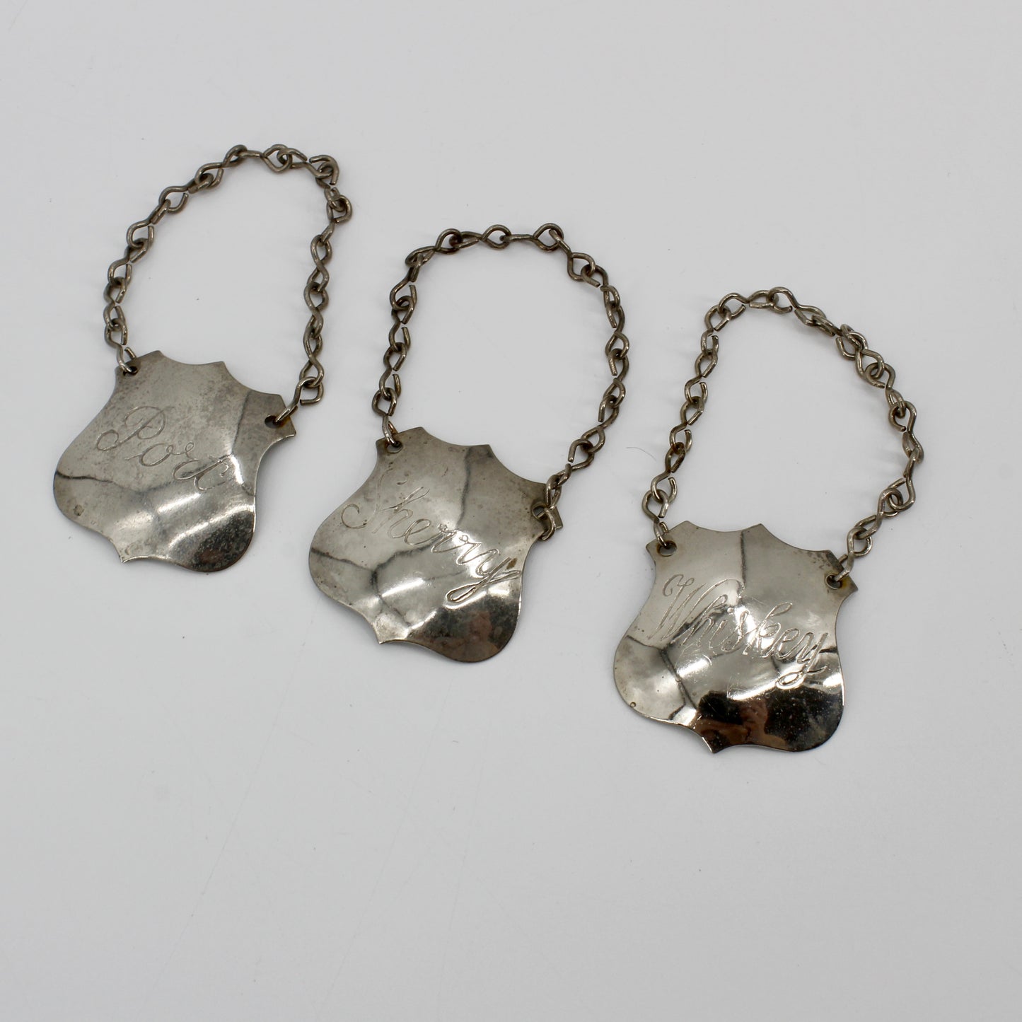 Trio of Sterling Silver Bottle Tags & Antique Book