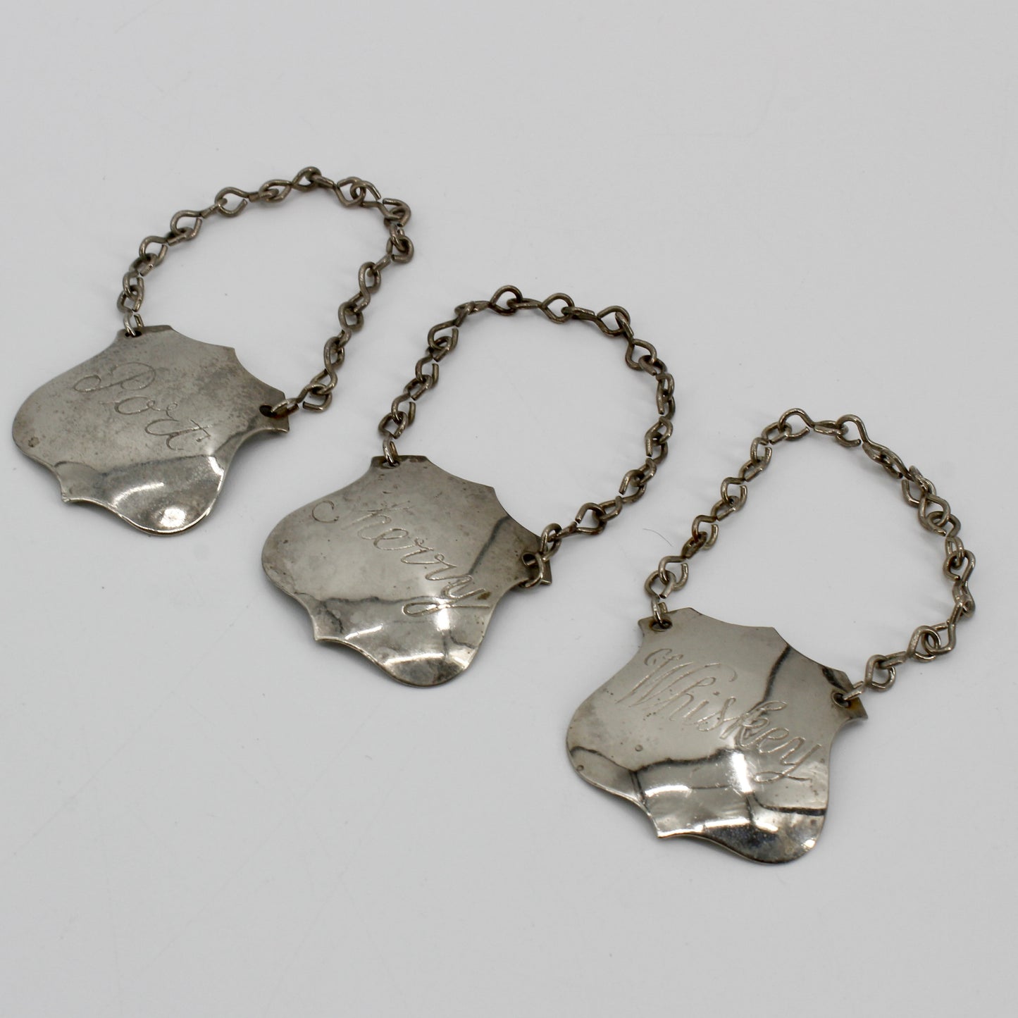 Trio of Sterling Silver Bottle Tags & Antique Book