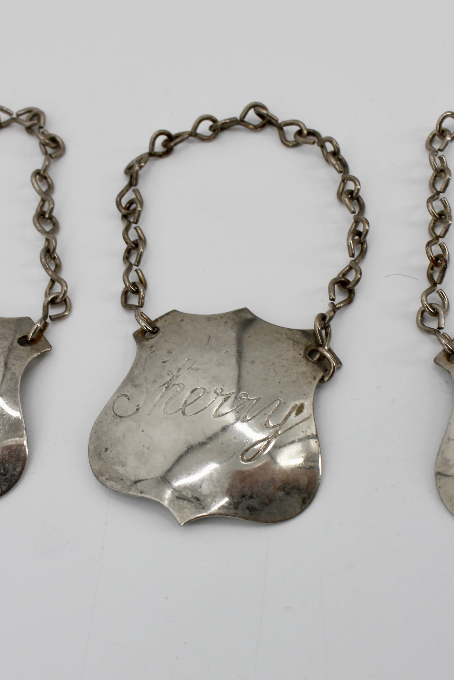 Trio of Sterling Silver Bottle Tags & Antique Book