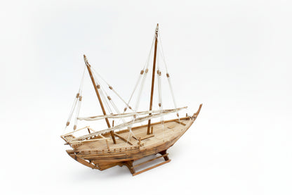 Wooden model sailboat on a white background